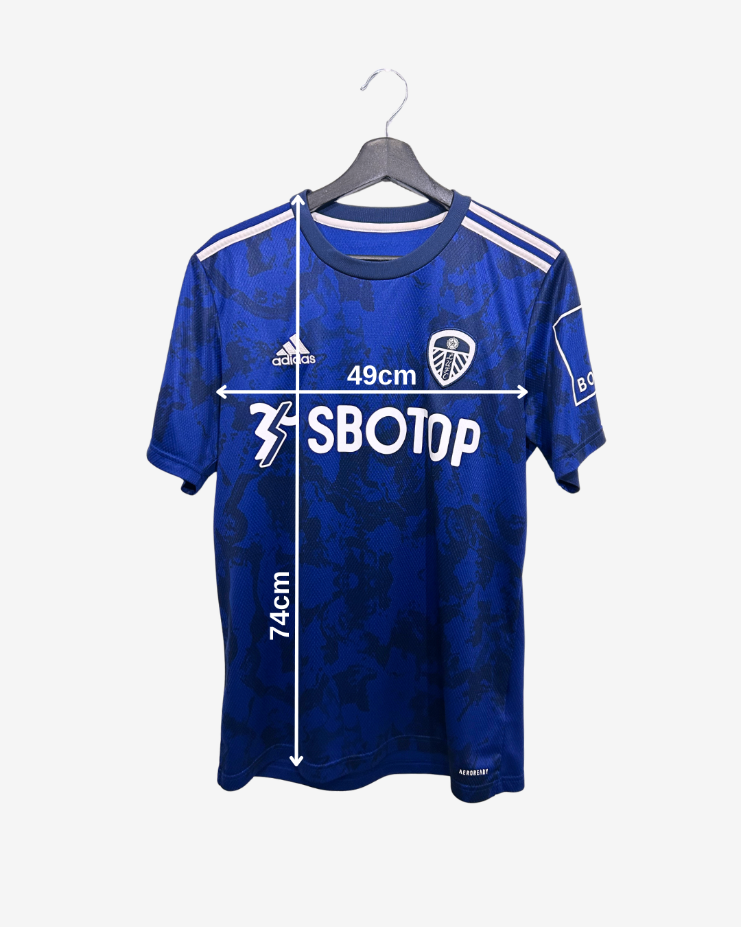 Blue sports jersey with branding and measurements on a white background