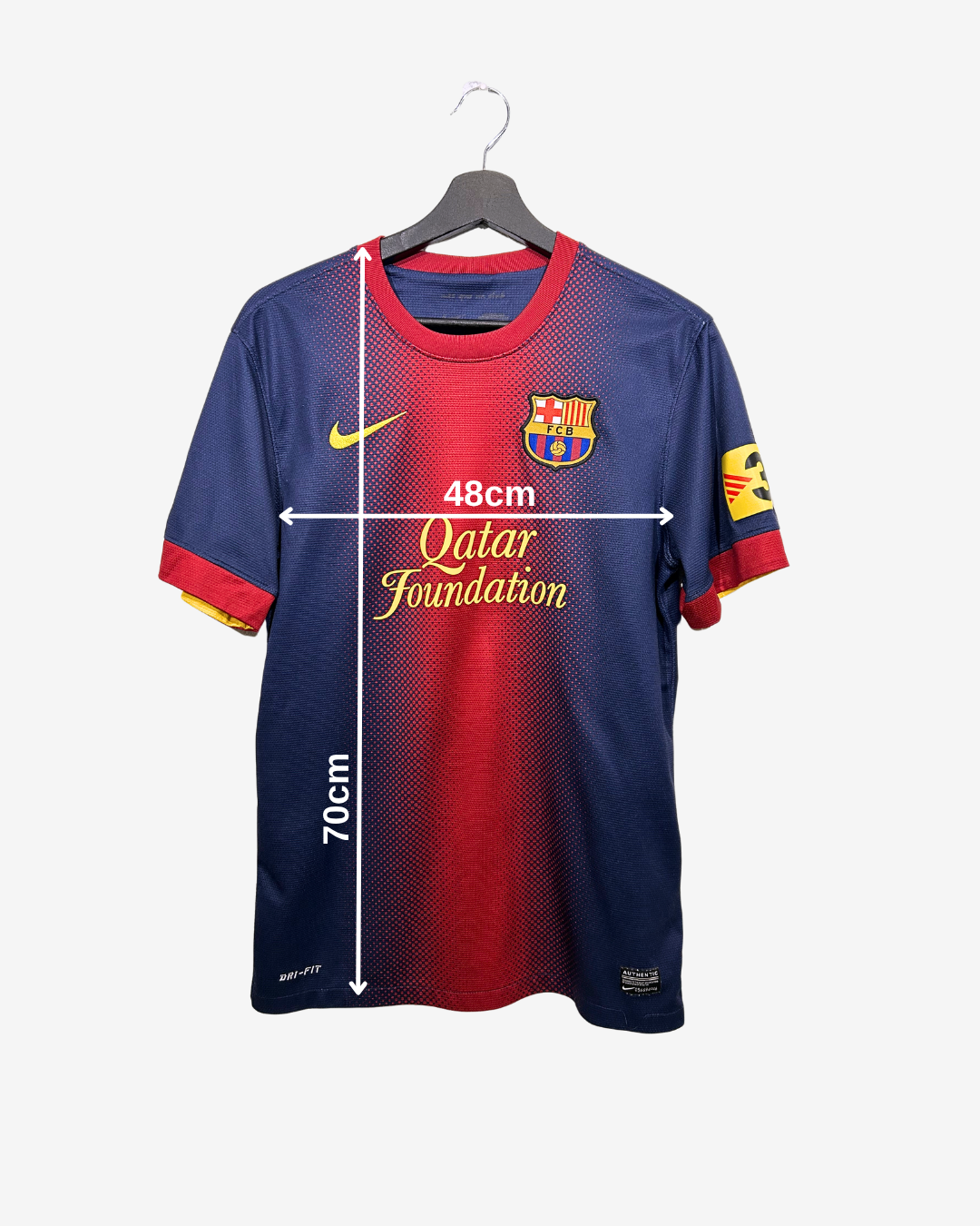 Barcelona football jersey with measurements on a white background