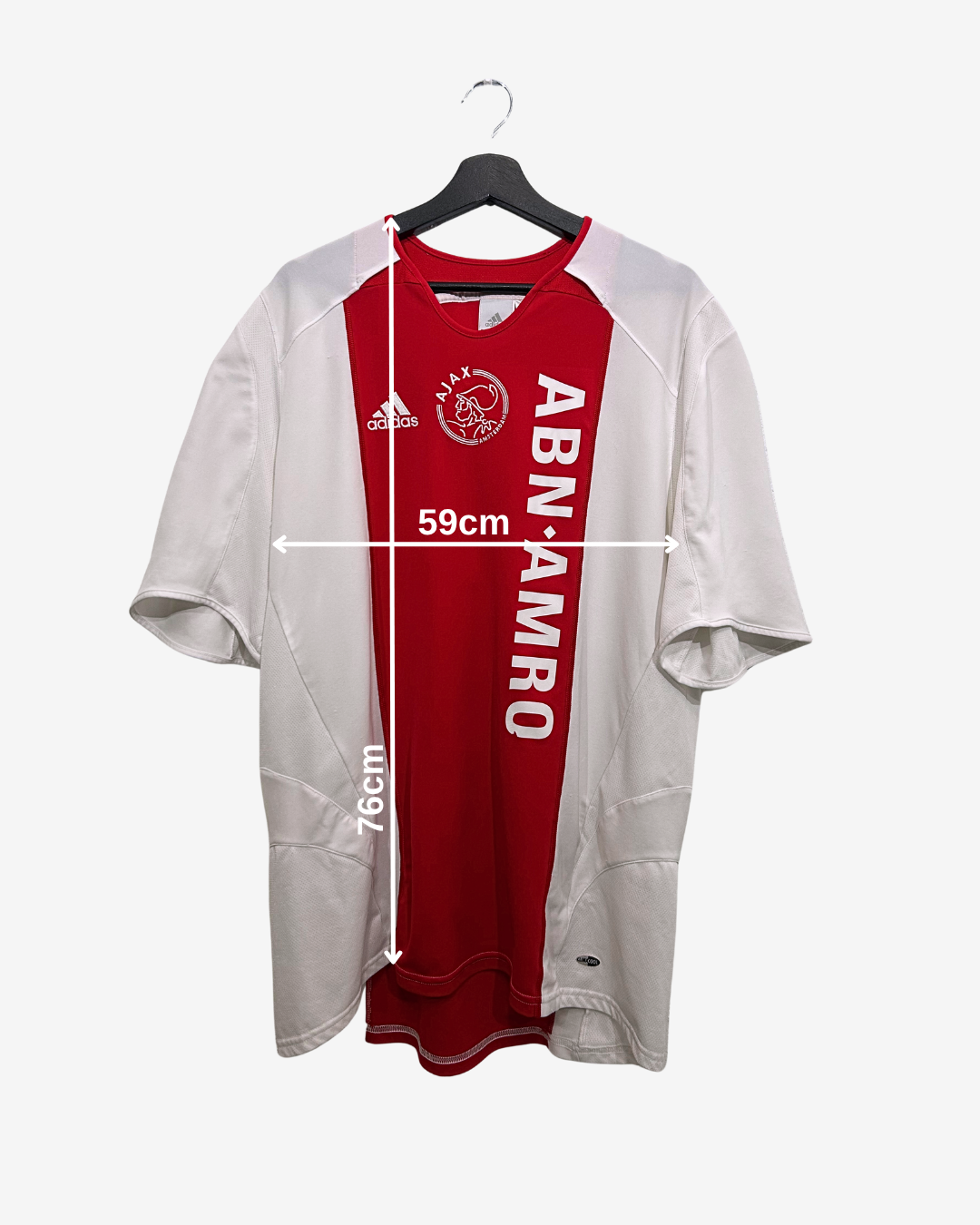 Red and white sports jersey on a hanger with visible branding.