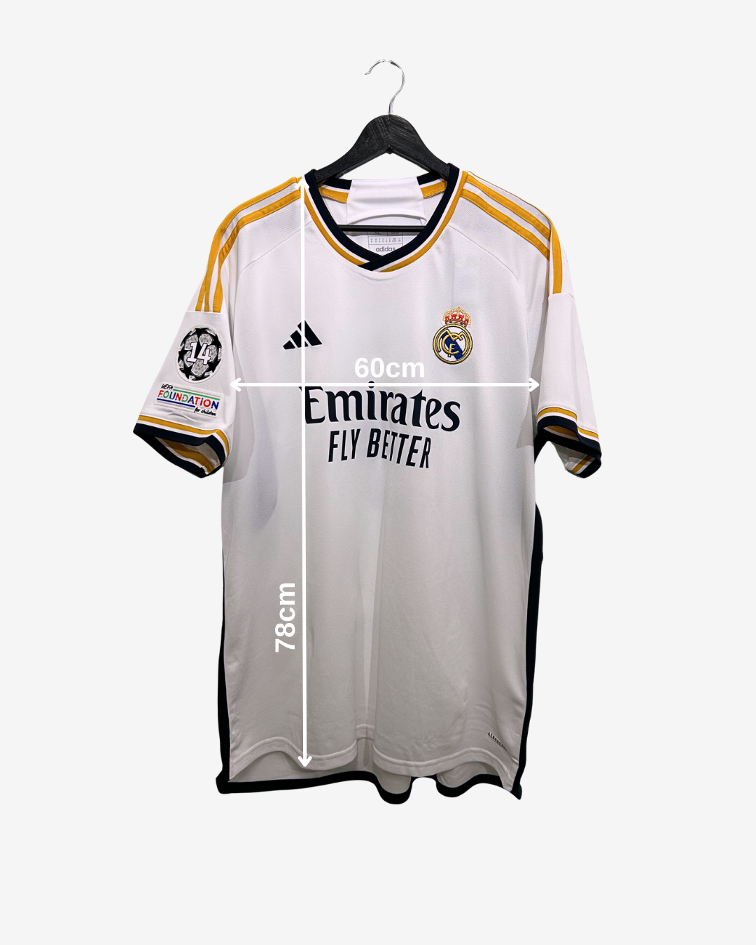 Real Madrid jersey with dimensions on a white background