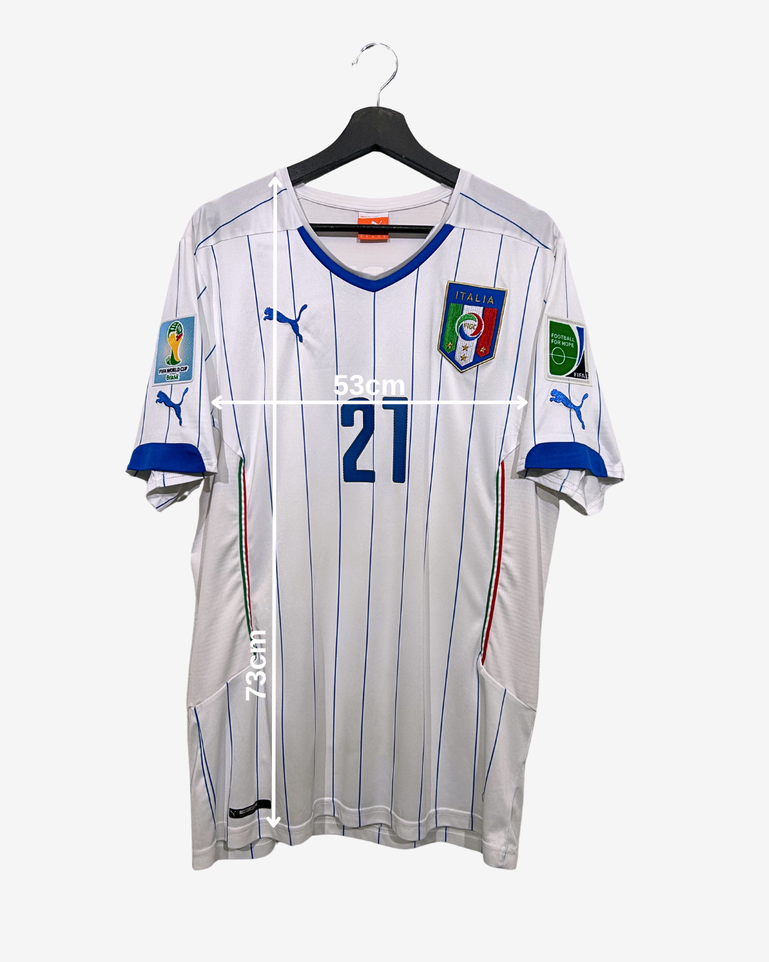 White soccer jersey with blue accents on a hanger, featuring Puma logo and Italian flag.