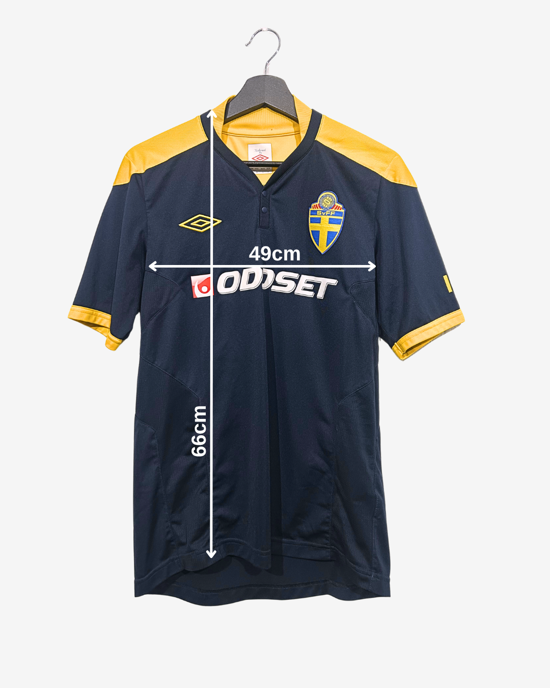 Navy and yellow sports jersey on a hanger with measurements and branding displayed.