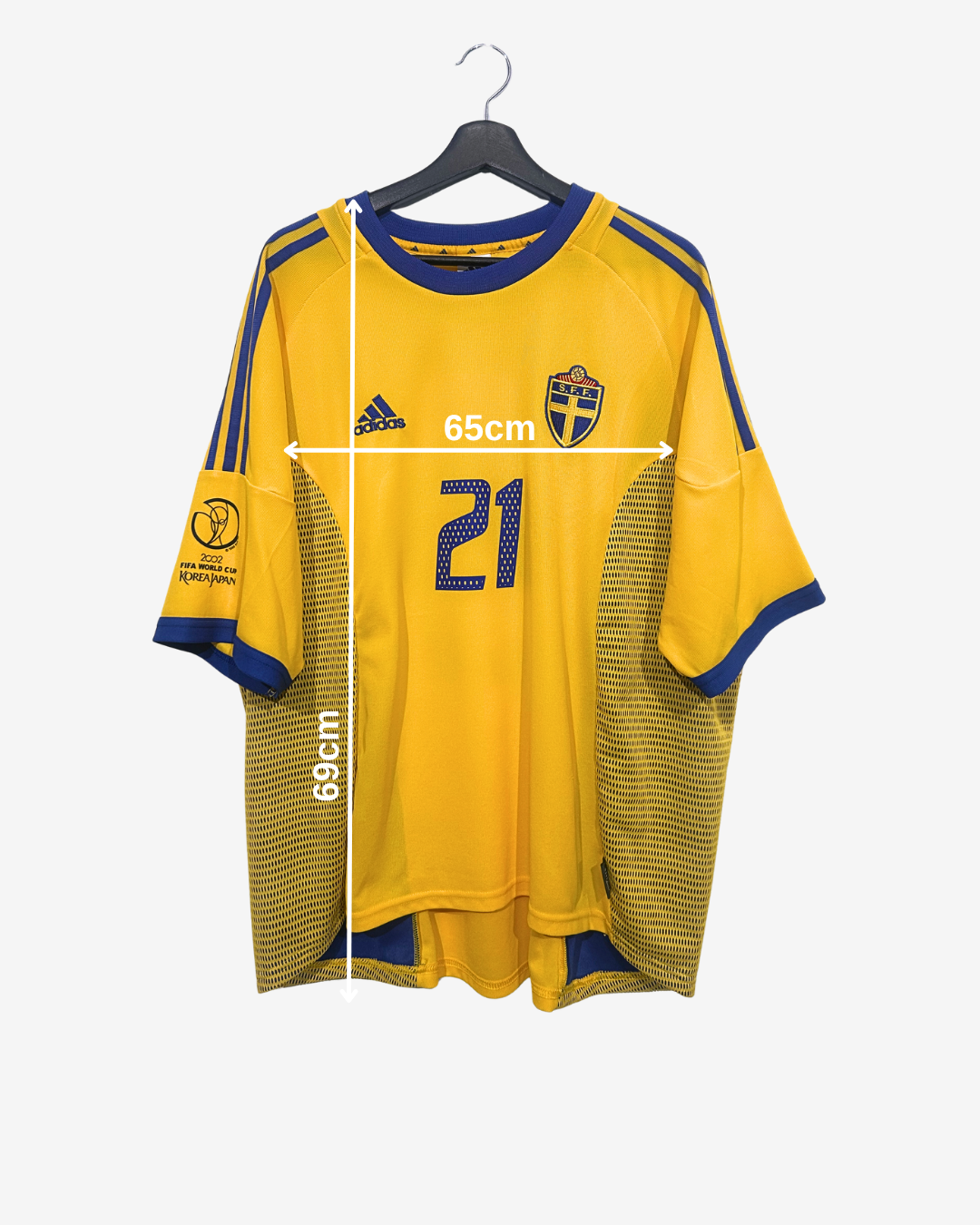 Yellow sports jersey with blue accents on a hanger, showing measurements.