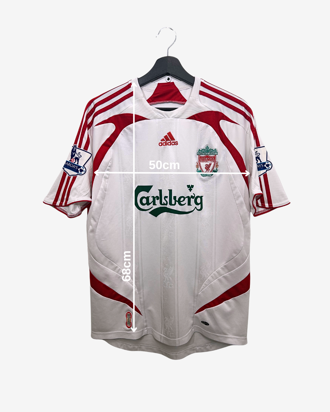 White sports jersey with red accents on a hanger, featuring Adidas and Carlsberg logos.