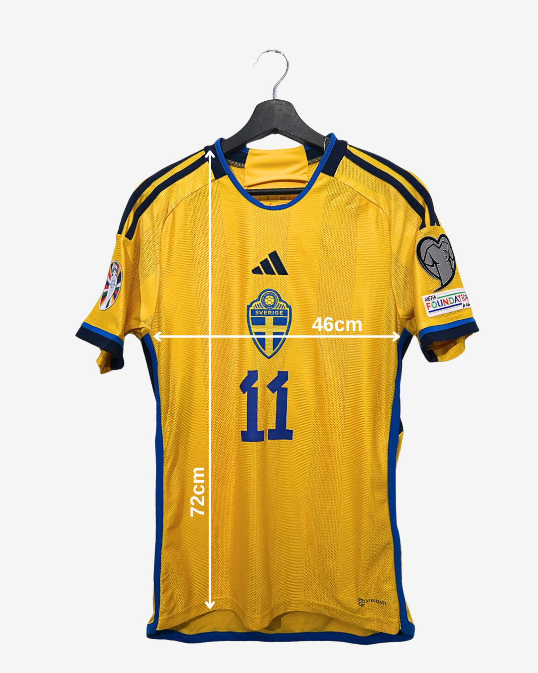 Yellow sports jersey with blue accents on a hanger, featuring measurements and logos.