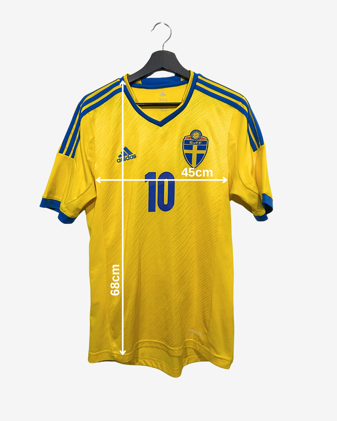 Yellow sports jersey with blue accents on a hanger, featuring Adidas logo and Swedish flag design.