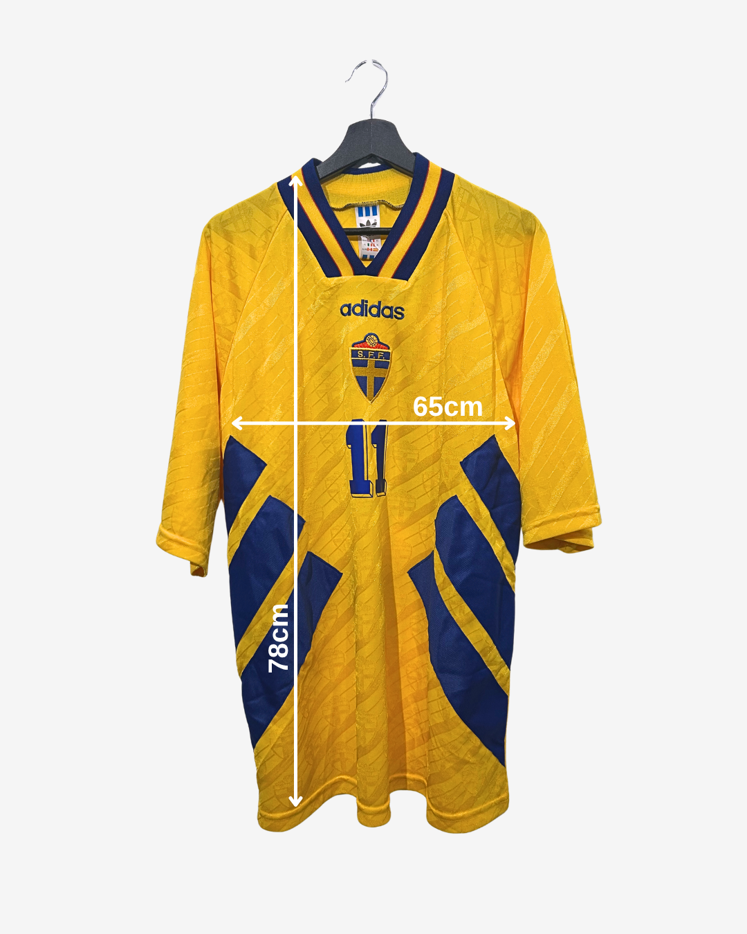 Yellow sports jersey with blue accents on a hanger, showing measurements.
