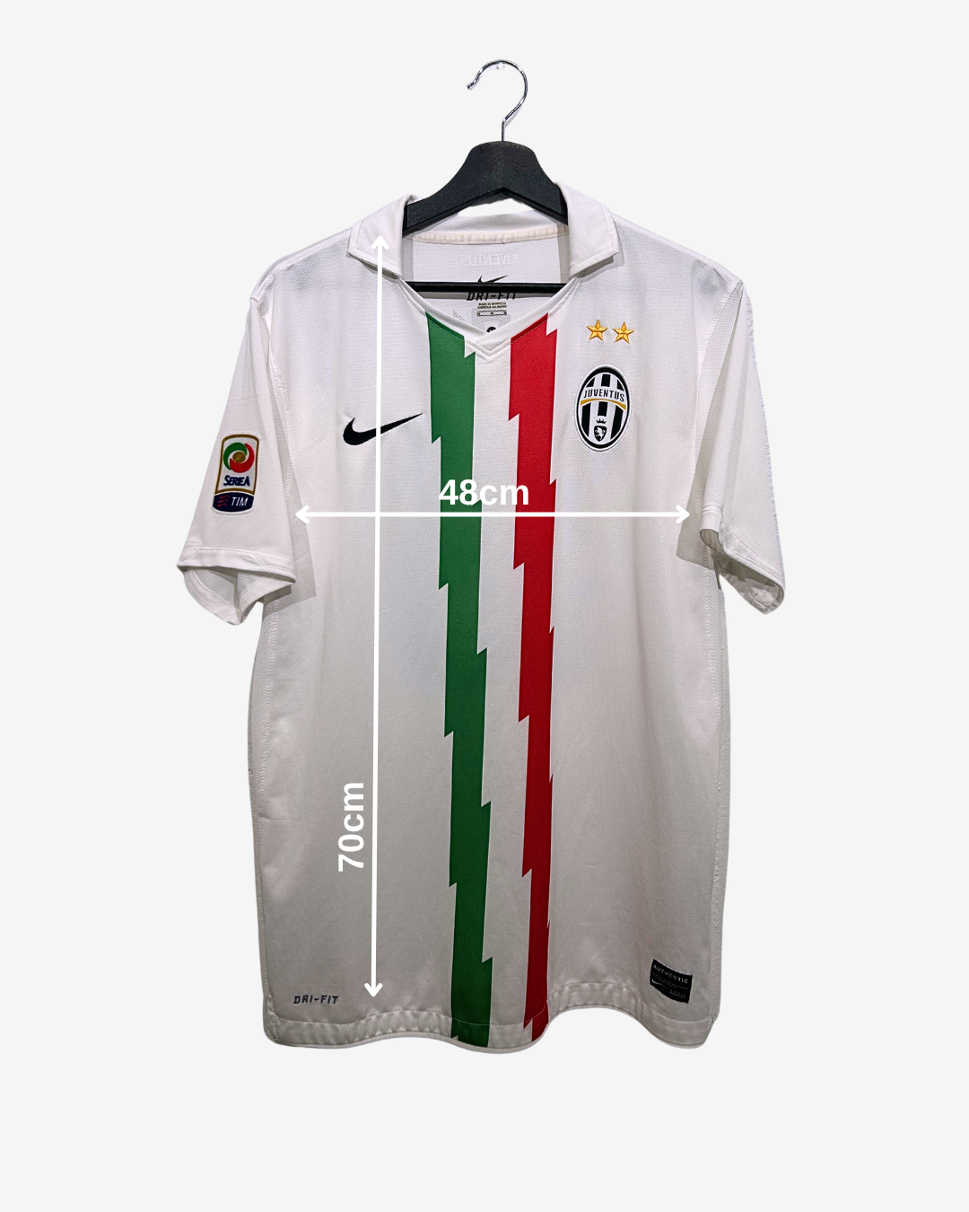 White sports jersey with red and green stripes on a hanger, featuring brand logos.