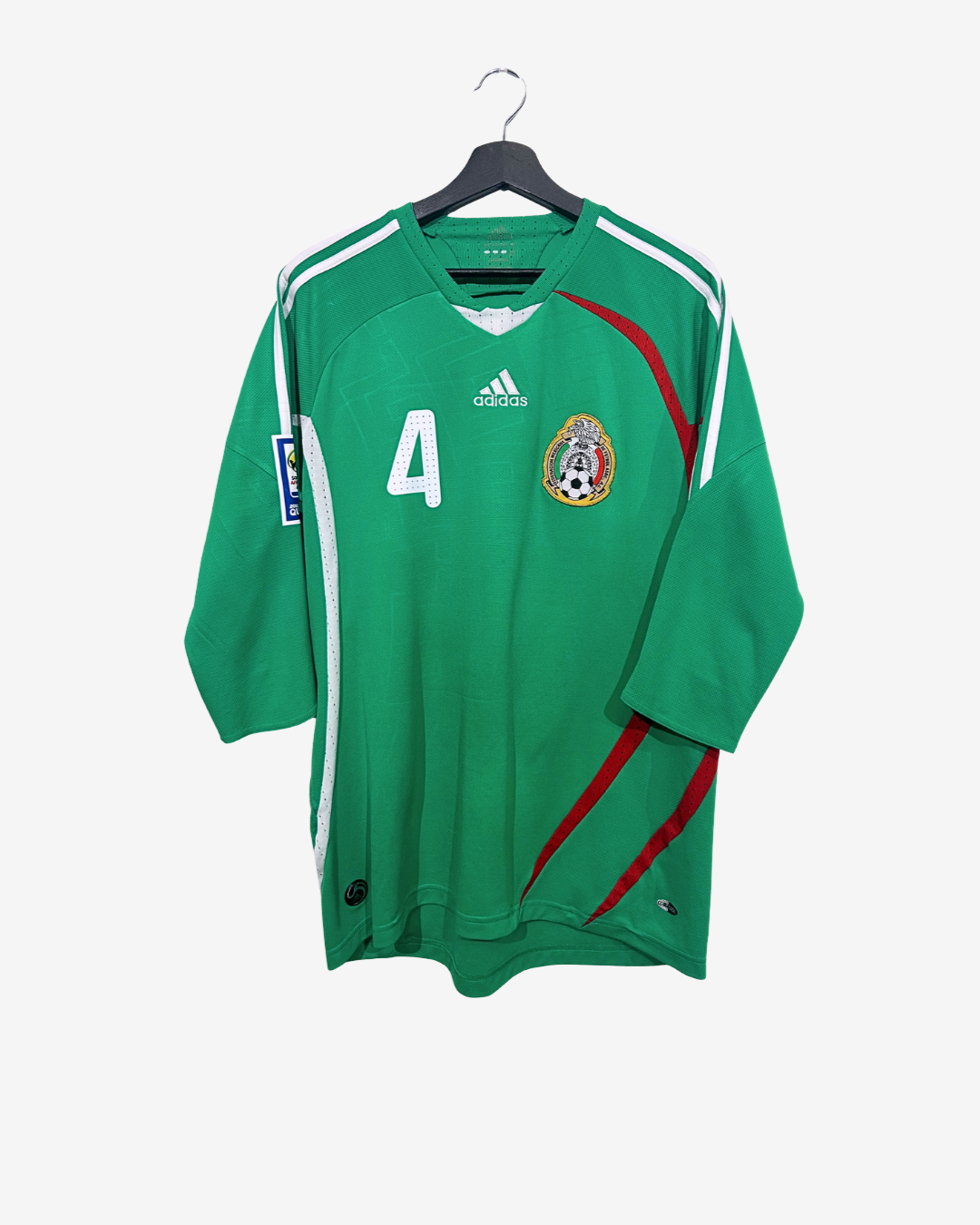 Green soccer jersey with red accents on a hanger against a white background