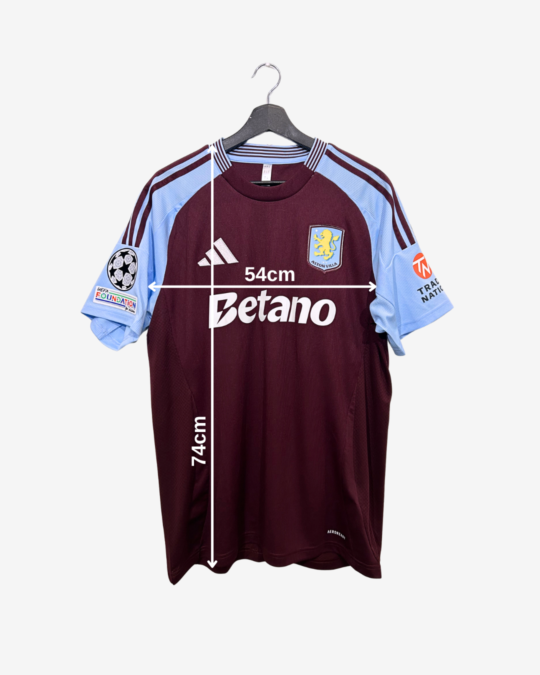 Maroon sports jersey with light blue sleeves on a hanger, featuring brand logos and measurements.