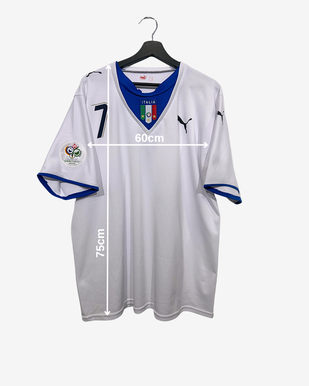 White sports jersey with blue accents on a hanger, featuring measurements and logos.