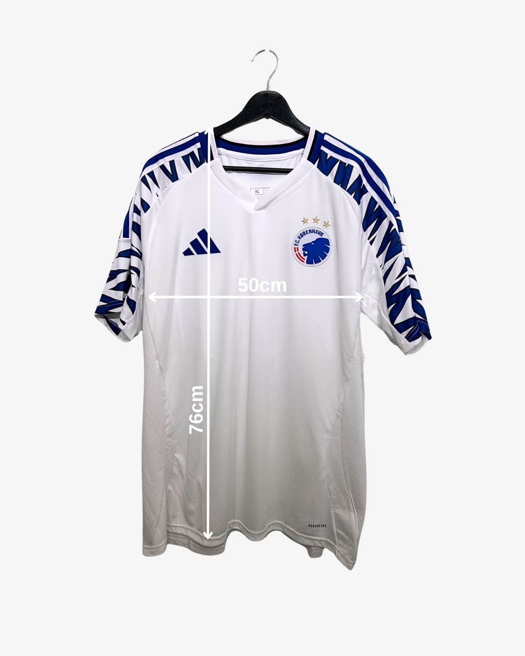 White sports jersey with blue accents on a hanger, measurement details included.