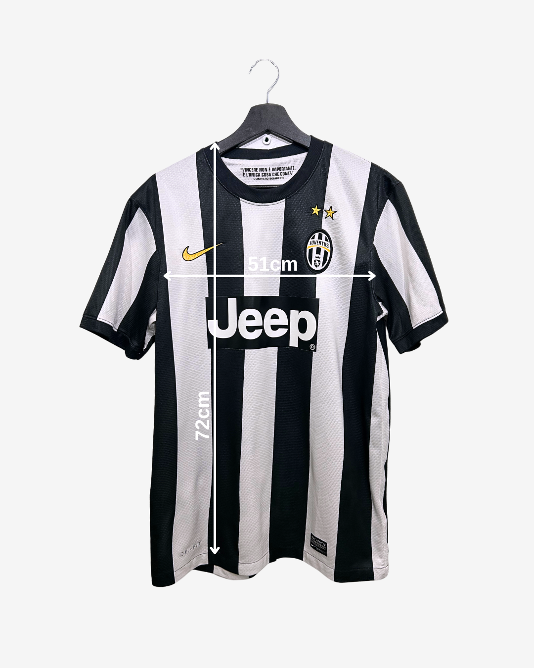 Black and white soccer jersey with brand logos on a hanger against a white background