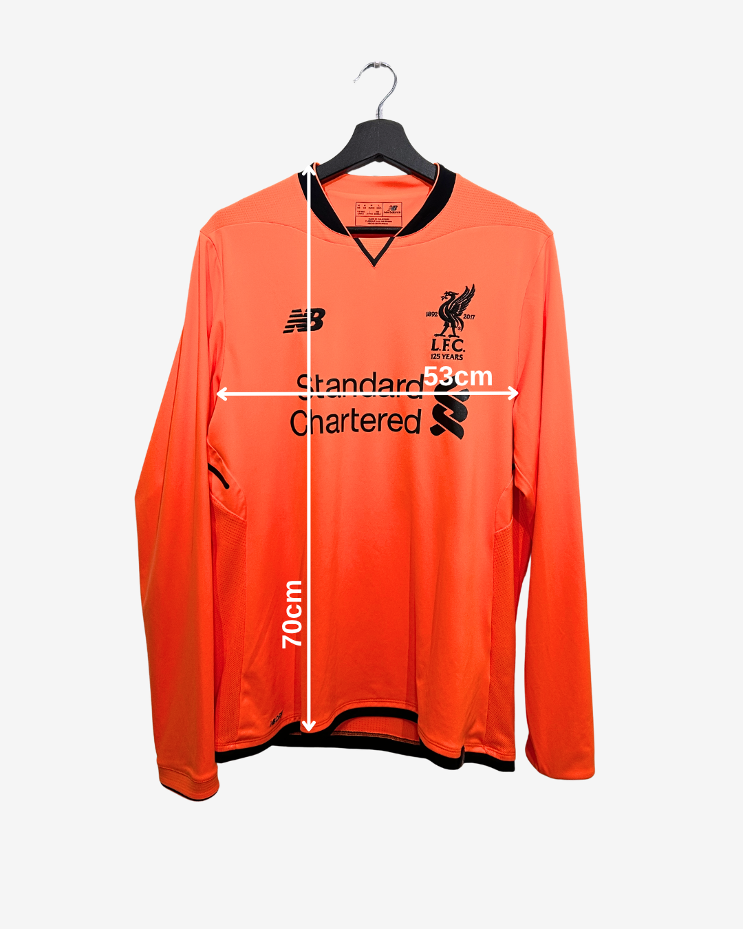 Orange sports jersey with measurements on a white background