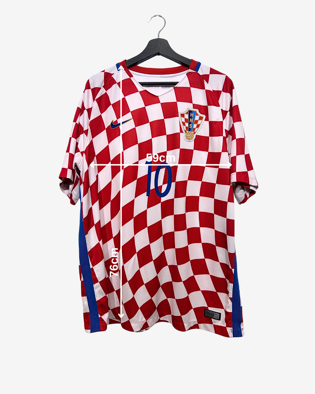 Red and white checkered sports jersey with blue accents on a hanger against a white background