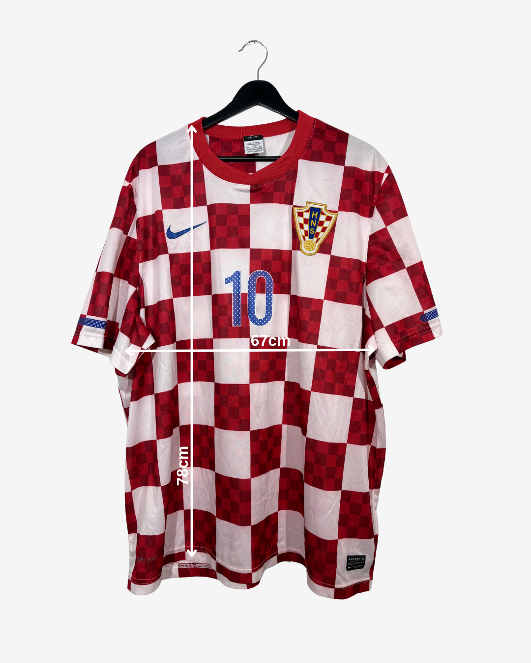 A red and white checkered Croatia soccer jersey with the number 10, displayed on a hanger against a light gray background with a white measurement overlay.