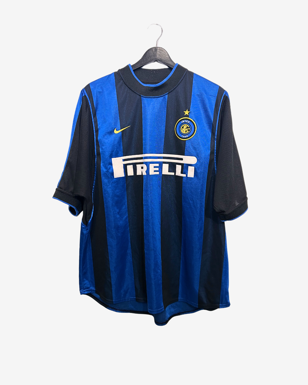 Blue and black sports jersey with Nike and Pirelli logos on a hanger against a white background