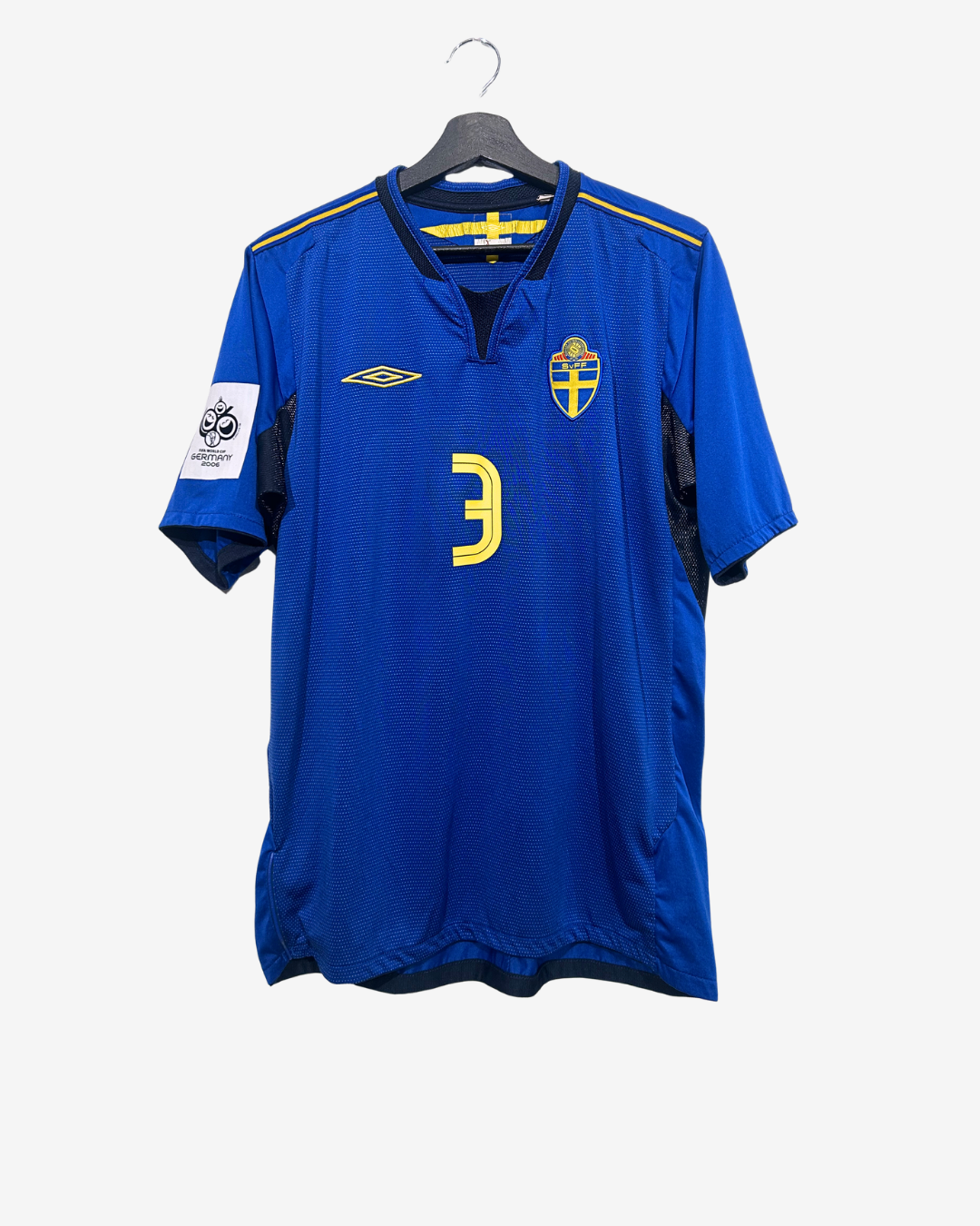 Blue sports jersey with number 3 on a hanger against a white background