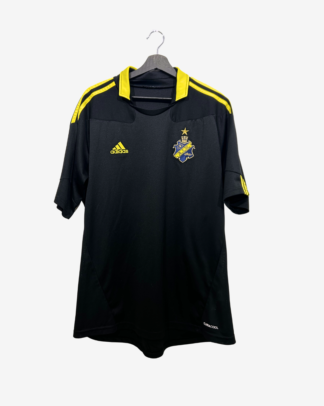 Black sports jersey with yellow accents on a hanger against a white background