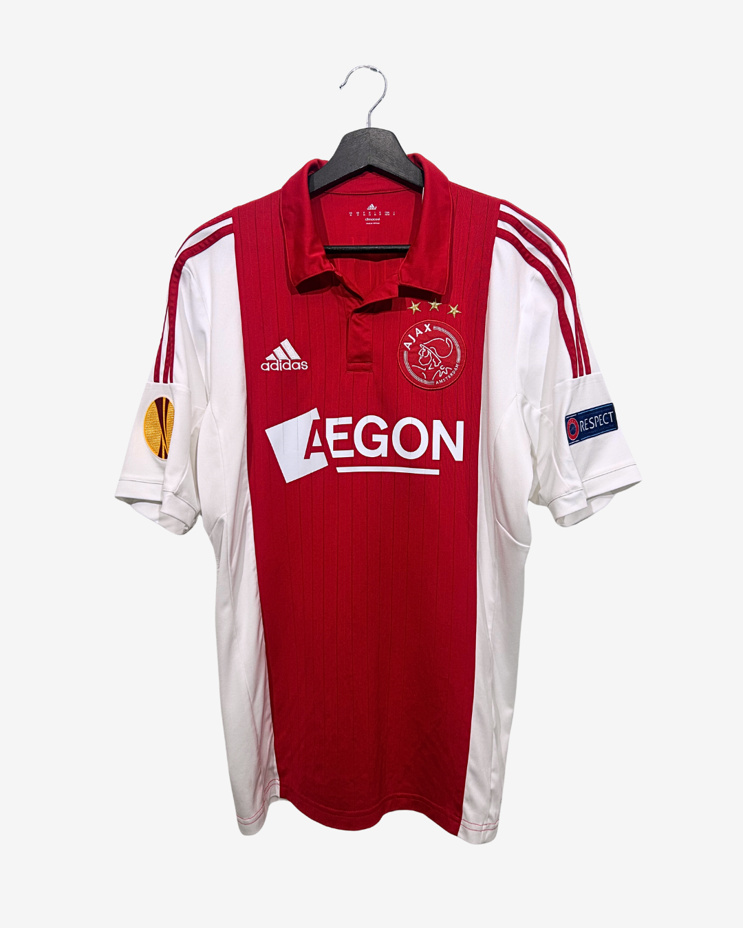 Red and white sports jersey with visible branding on a hanger against a white background