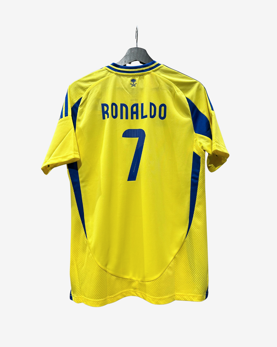 A yellow soccer jersey with 'RONALDO' and the number '7' printed in blue on the back, hanging on a hanger against a light gray background.