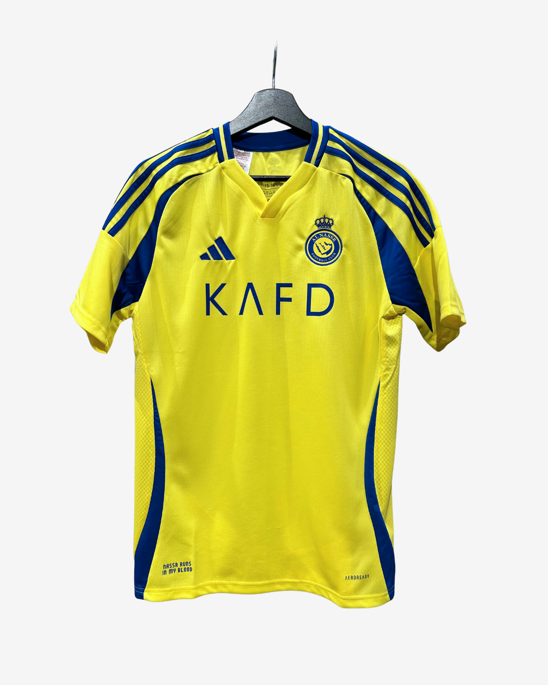 A yellow and blue Adidas Swindon Town soccer jersey hanging on a black hanger against a light gray background. The jersey features the club's crest on the chest, 'KAFD' sponsor text, and blue shoulder stripes.