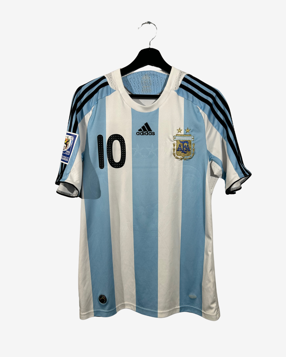 Argentina soccer jersey with number 10 on a hanger against a white background