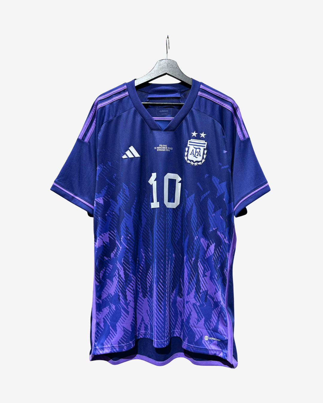 A blue and purple Argentina national football team jersey with the number 10, hanging on a gray hanger against a light gray background.