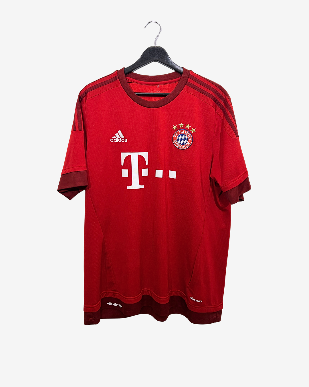 Red sports jersey with Adidas logo and Bayern Munich logo on a hanger against a white background