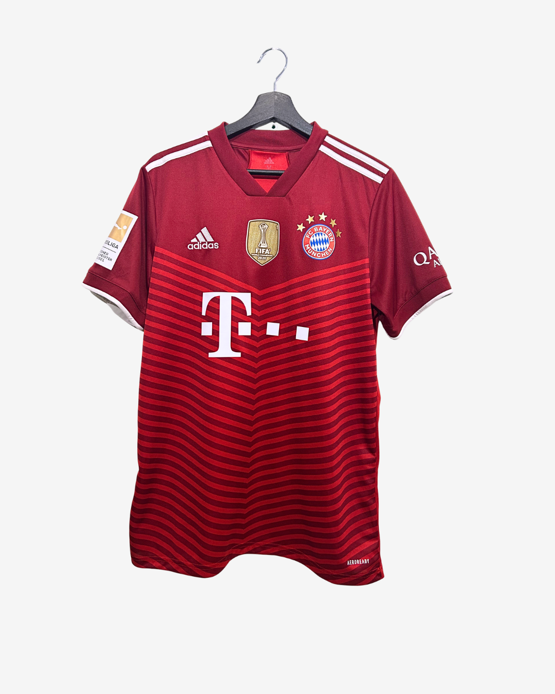Red sports jersey with Adidas and Bayern Munich logos on a white background