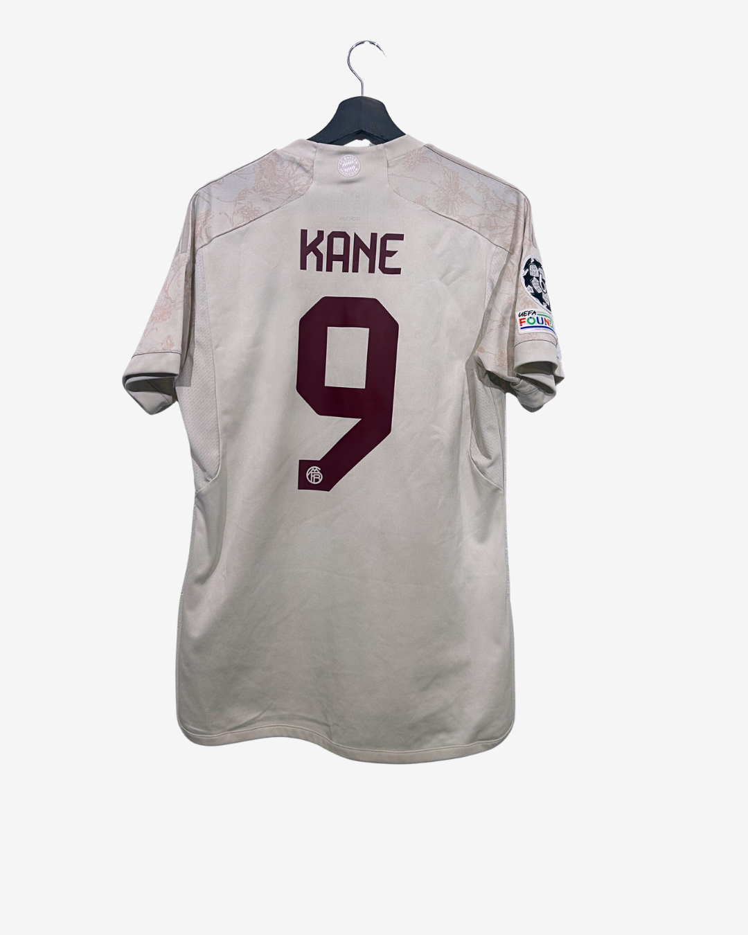 Gray sports jersey with 'Kane' and number '9' on a white background