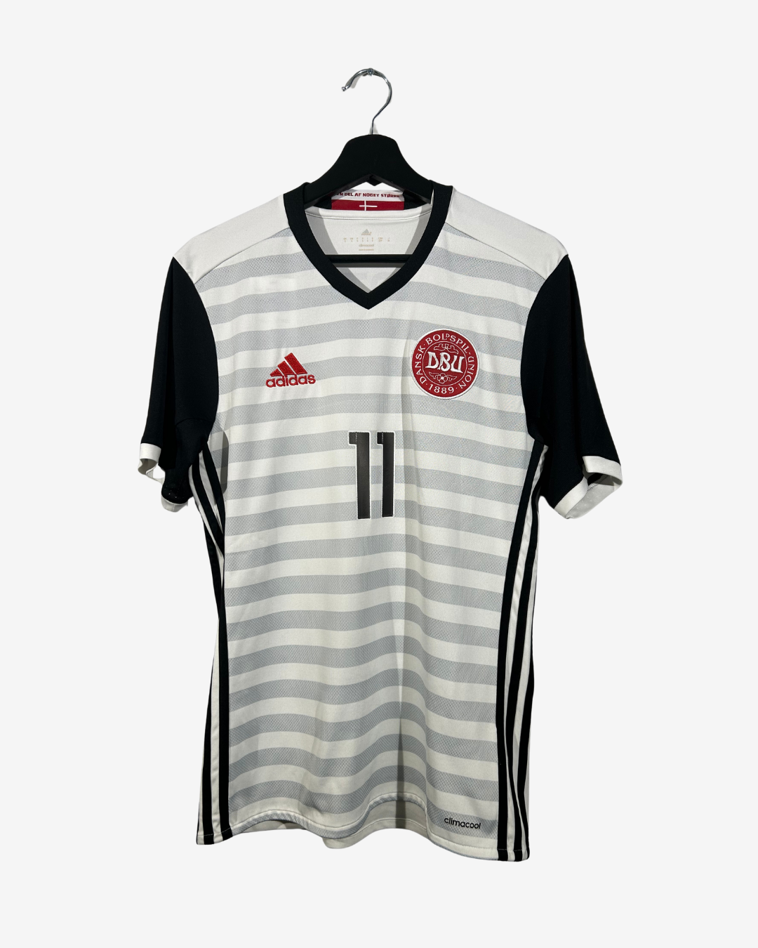 Gray and black striped soccer jersey with Adidas logo on a white background