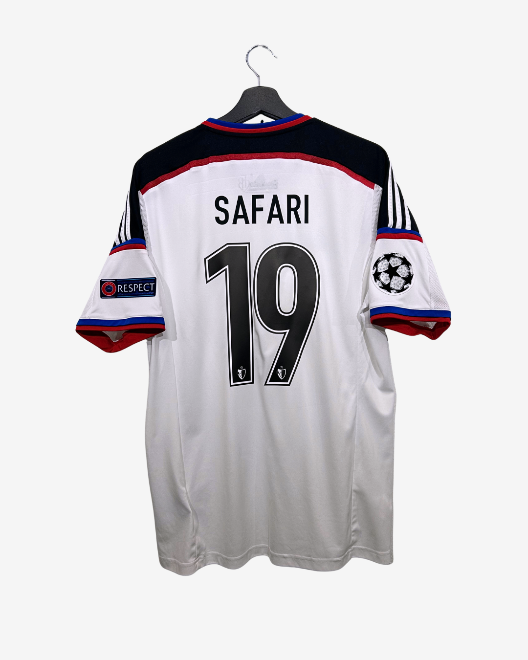 White sports jersey with 'Safari' and number '19' on a hanger against a white background
