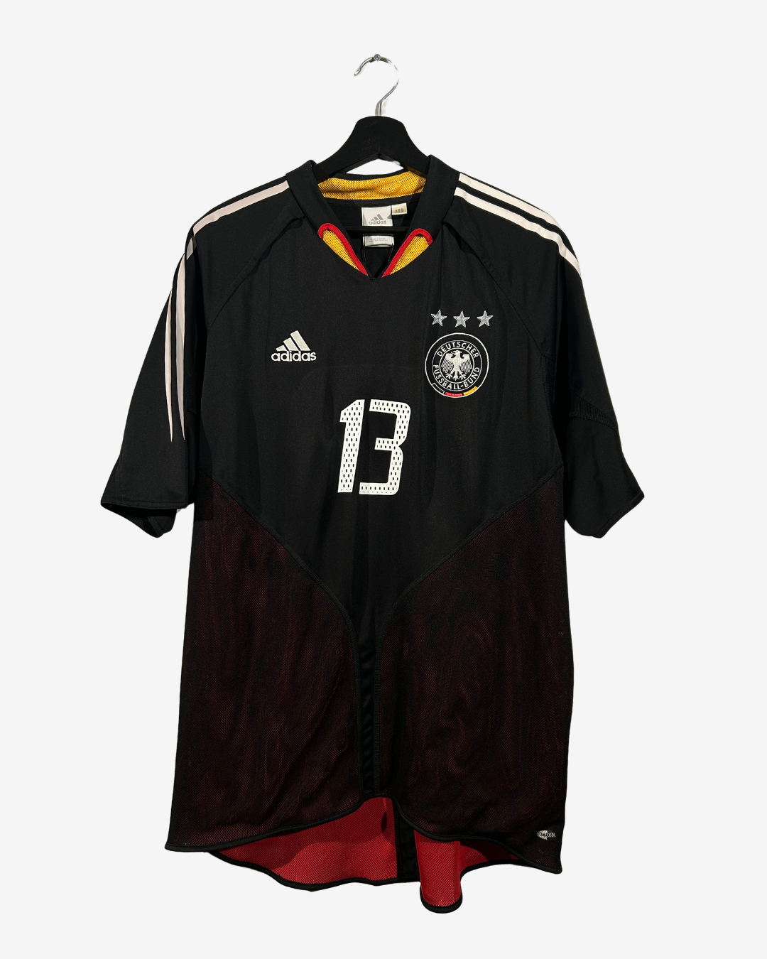Black sports jersey with number 13 on a hanger against a white background
