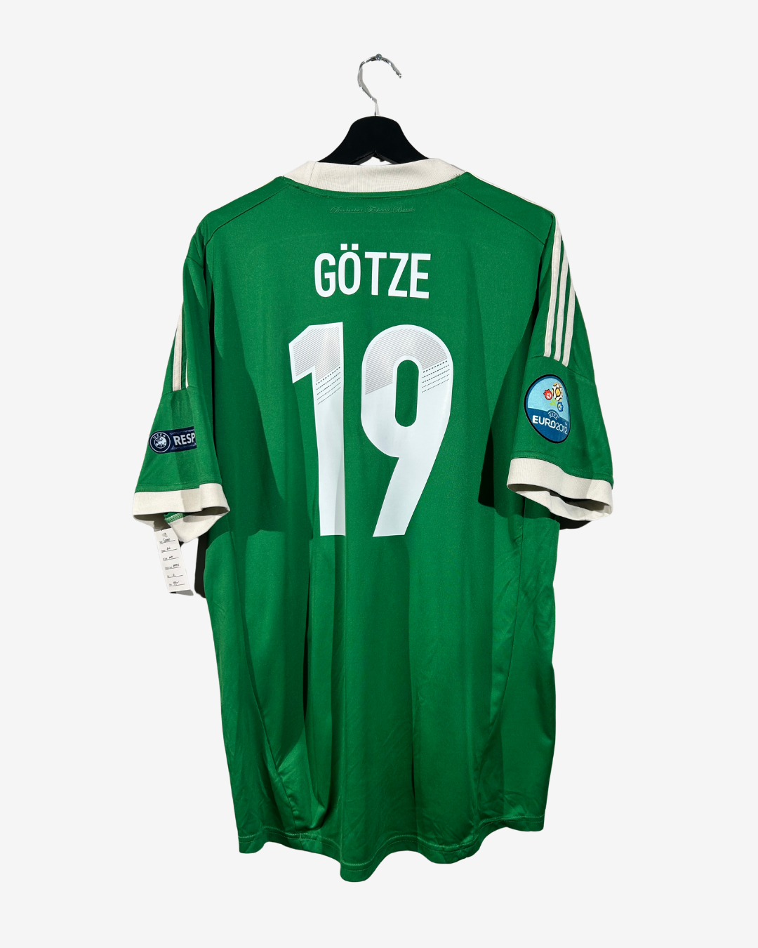 Green sports jersey with 'Götze' and number '19' on a hanger against a white background