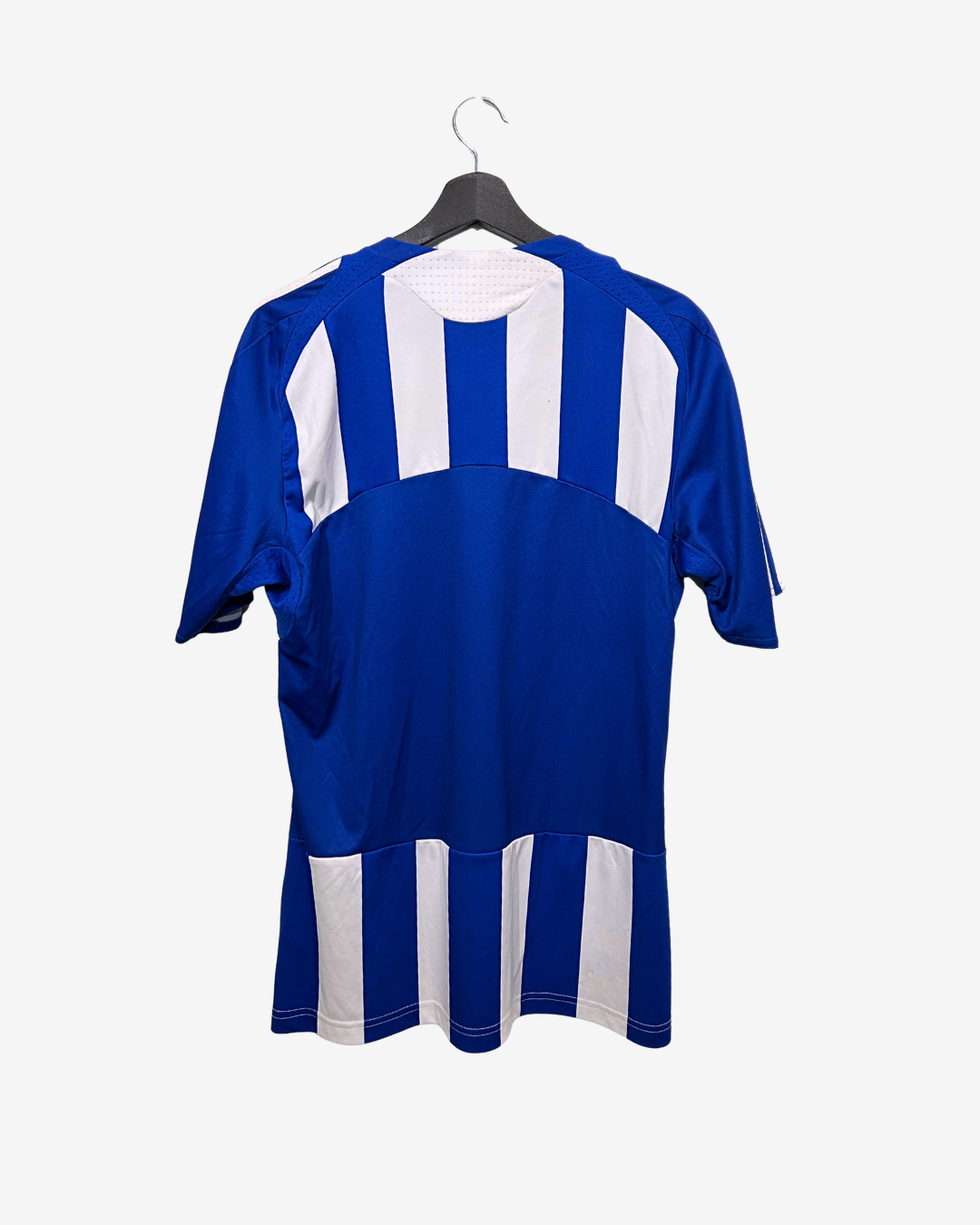 Blue and white sports jersey on a hanger against a white background