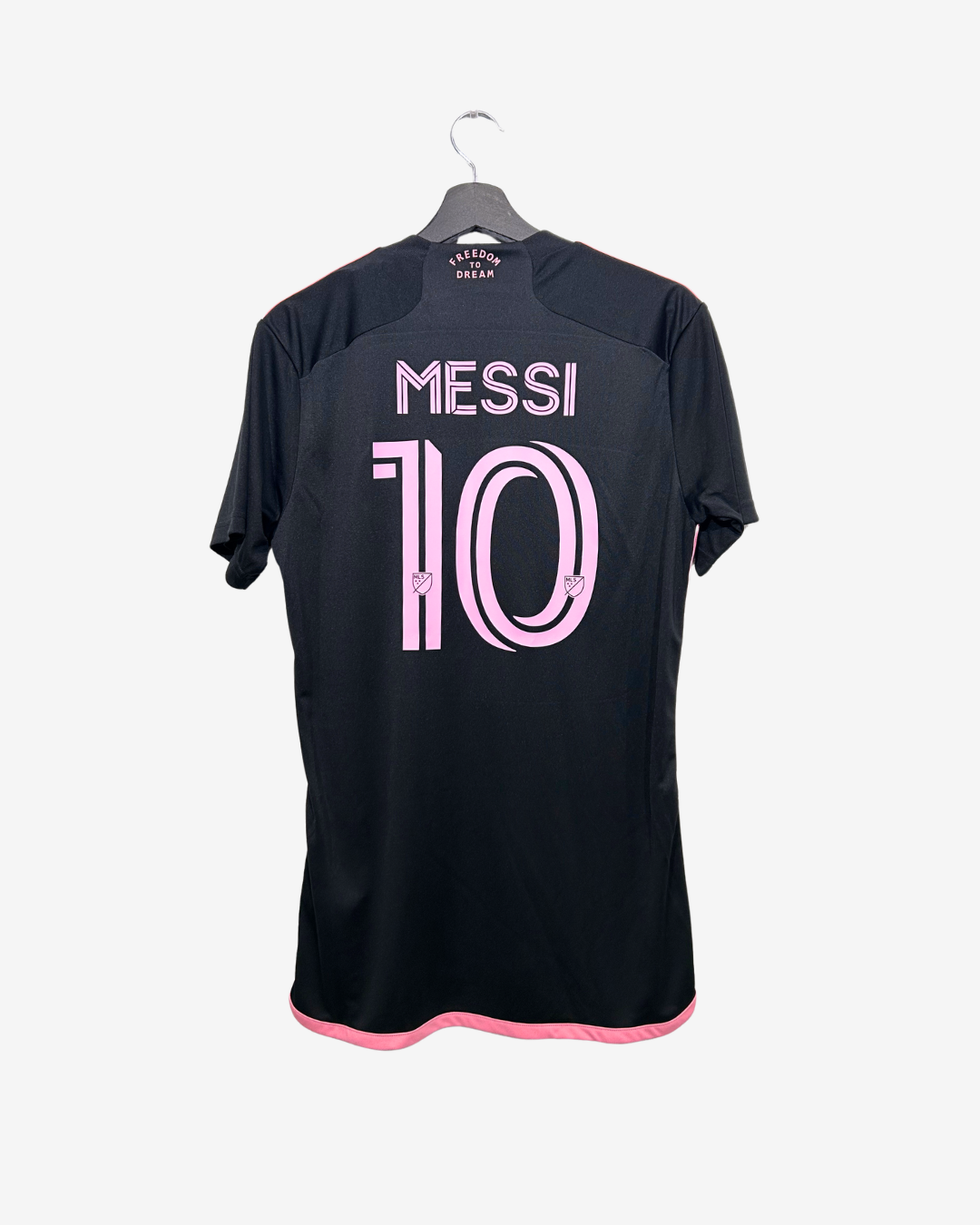 Black sports jersey with 'Messi 10' printed on a hanger against a white background