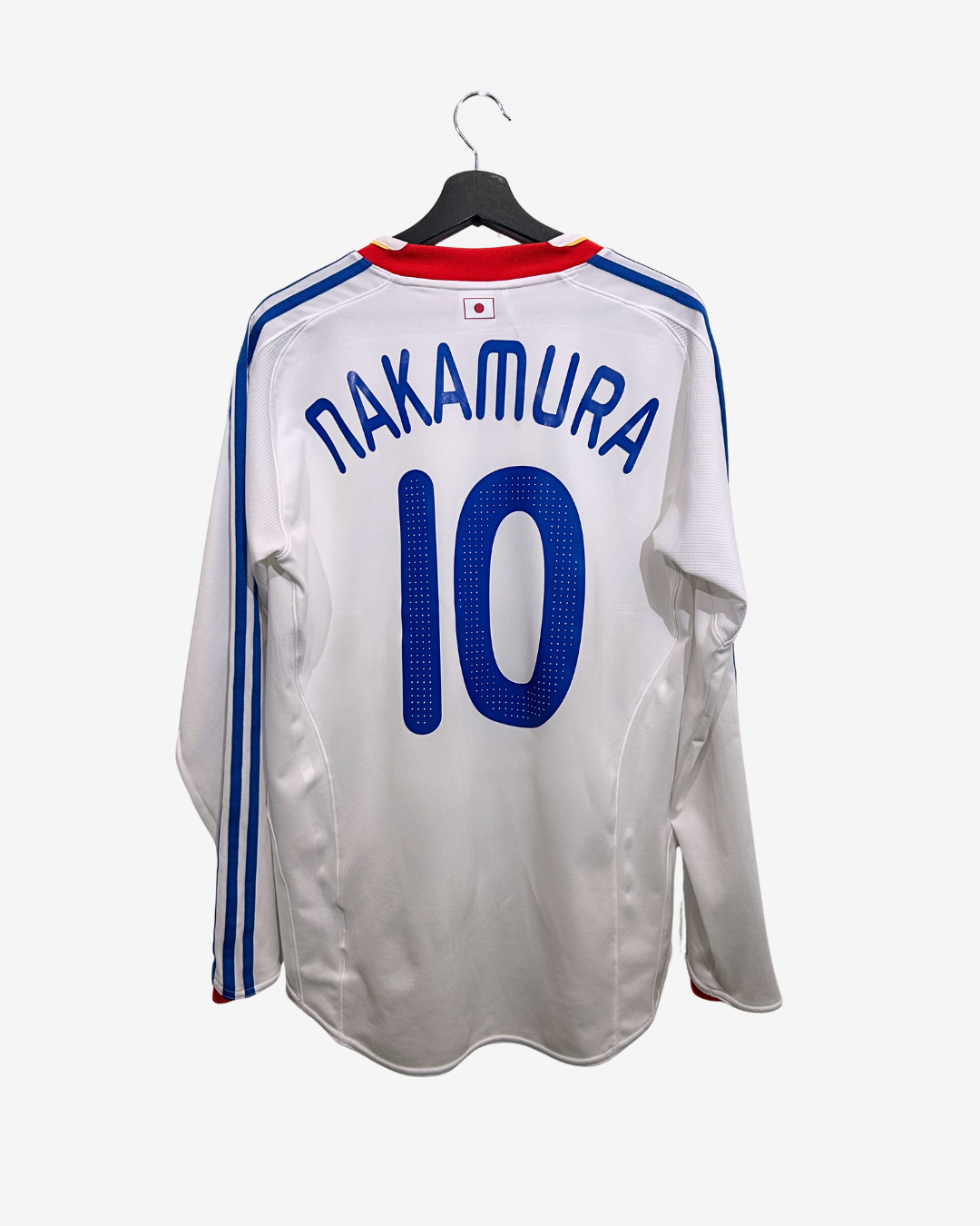 White sports jersey with 'Nakamura' and number '10' on a hanger against a white background