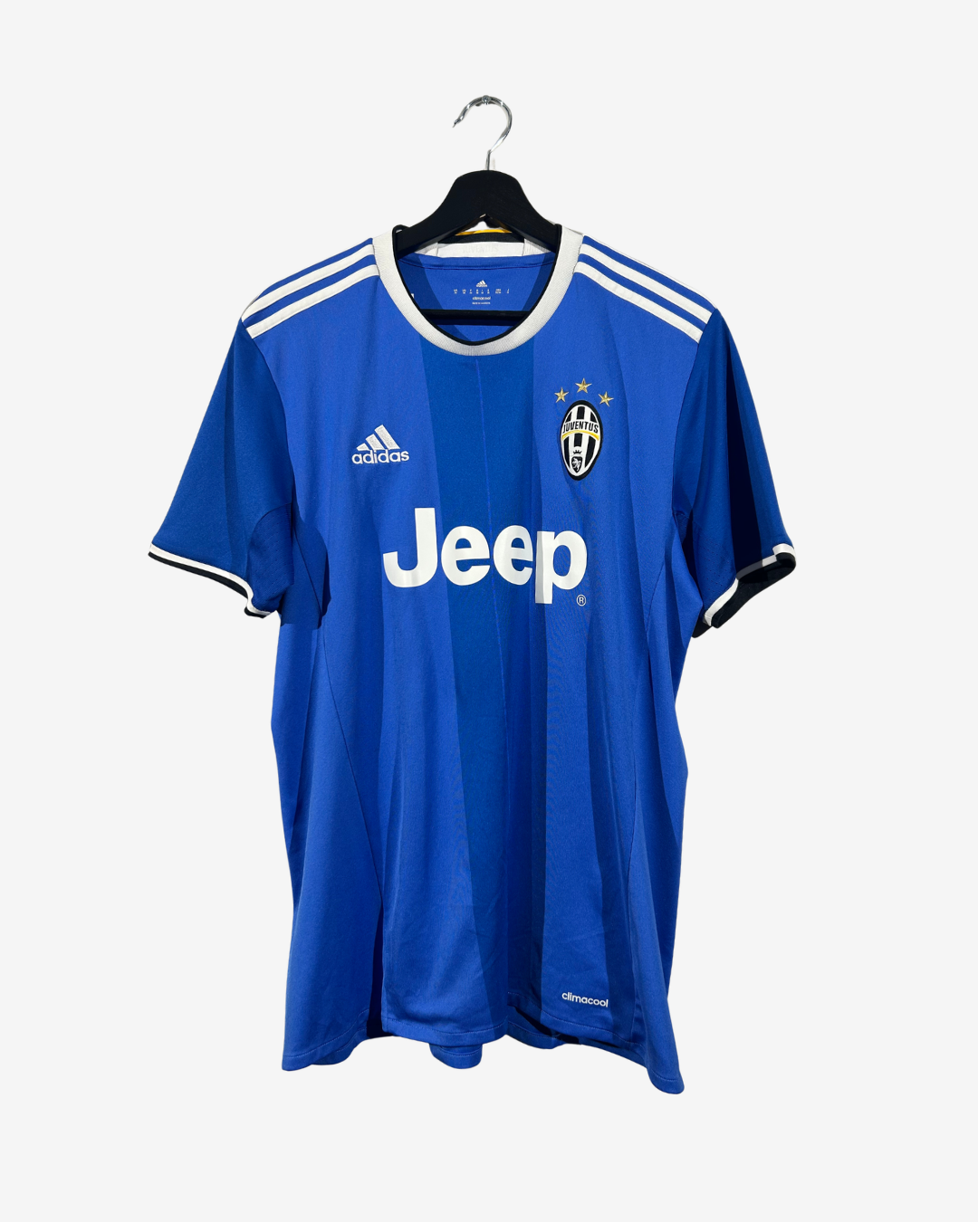 A blue Adidas Juventus soccer jersey with white stripes, a white Jeep sponsor logo, and the club crest, hanging on a black hanger against a light gray background.
