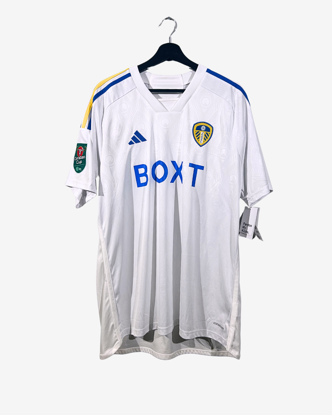 White sports jersey with branding on a hanger against a white background
