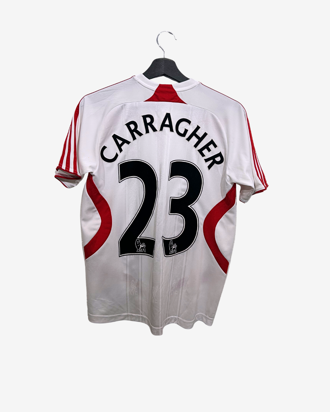 White sports jersey with red accents and 'Carragher 23' printed on a hanger against a white background