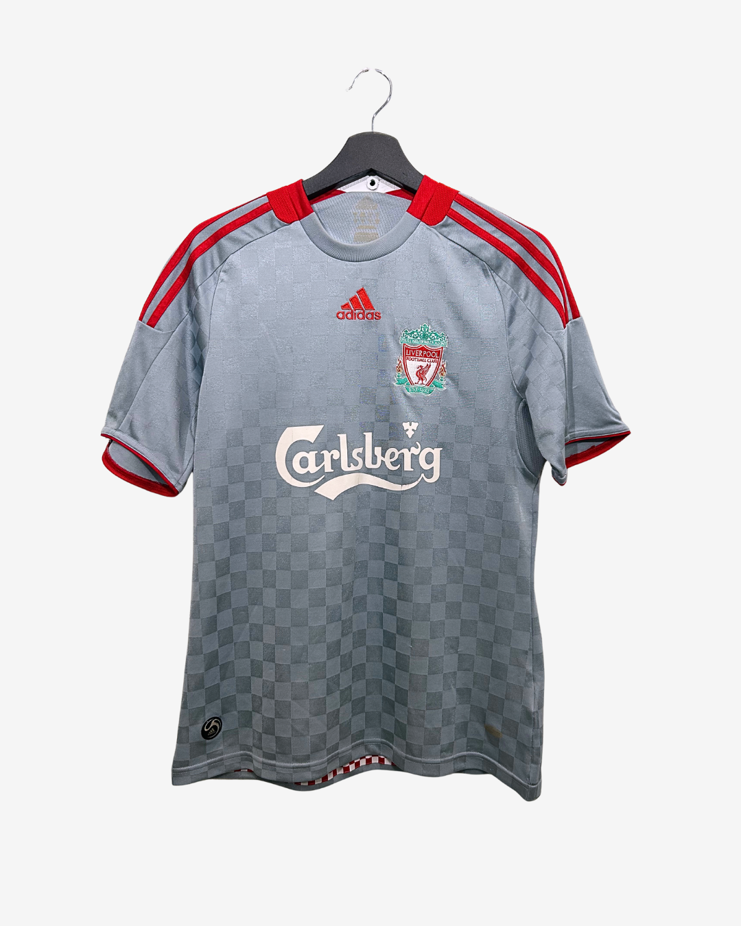 Gray sports jersey with red accents on a hanger against a white background