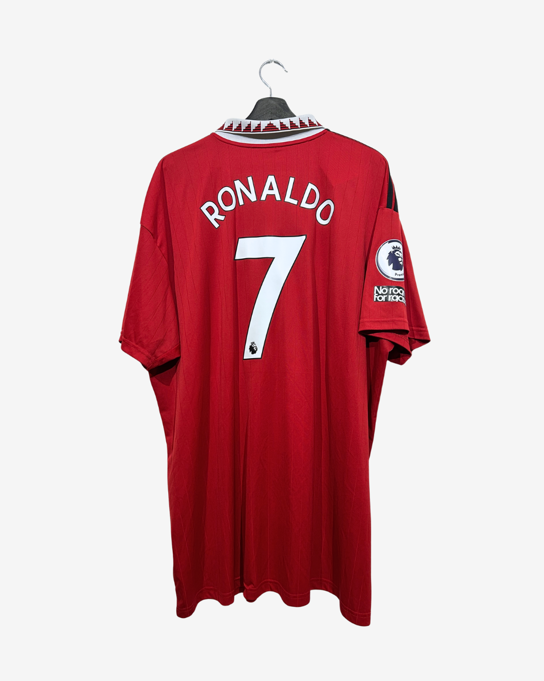 A red long-sleeve soccer jersey with 'RONALDO' and the number '7' printed in white on the back, hanging on a black hanger against a light gray background. A Premier League patch is visible on the sleeve.