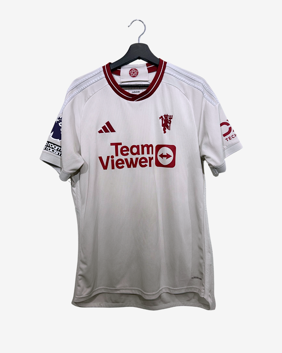 White sports jersey with red and black branding on a white background