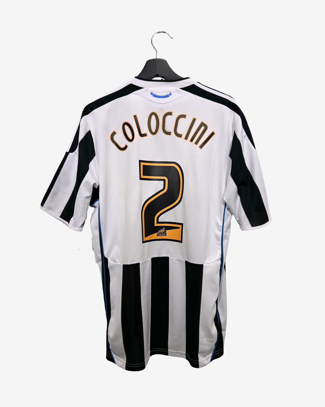 White sports jersey with black stripes and 'Coloccini 2' printed on a white background