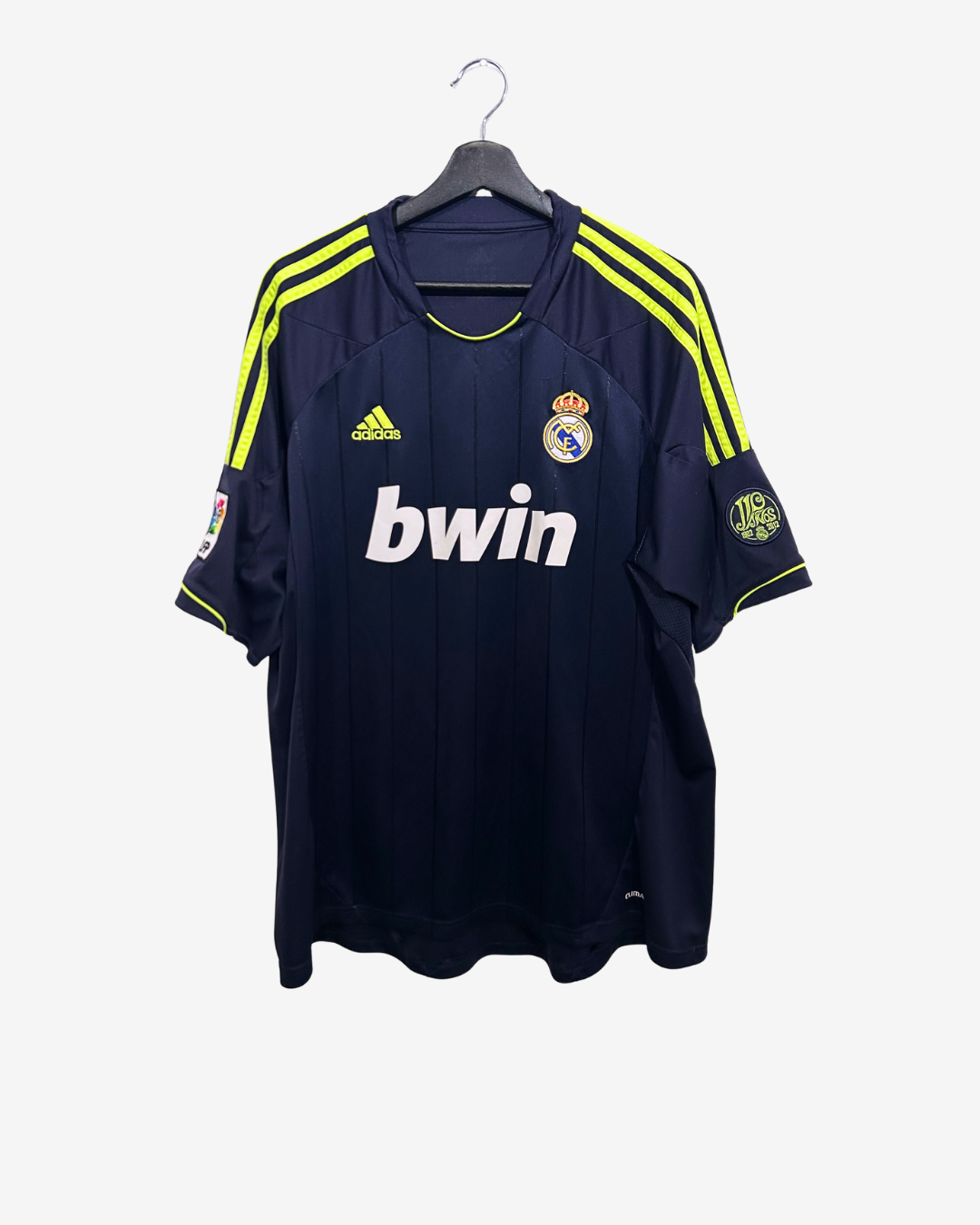 Navy blue sports jersey with yellow stripes on a hanger, featuring Adidas and bwin logos.