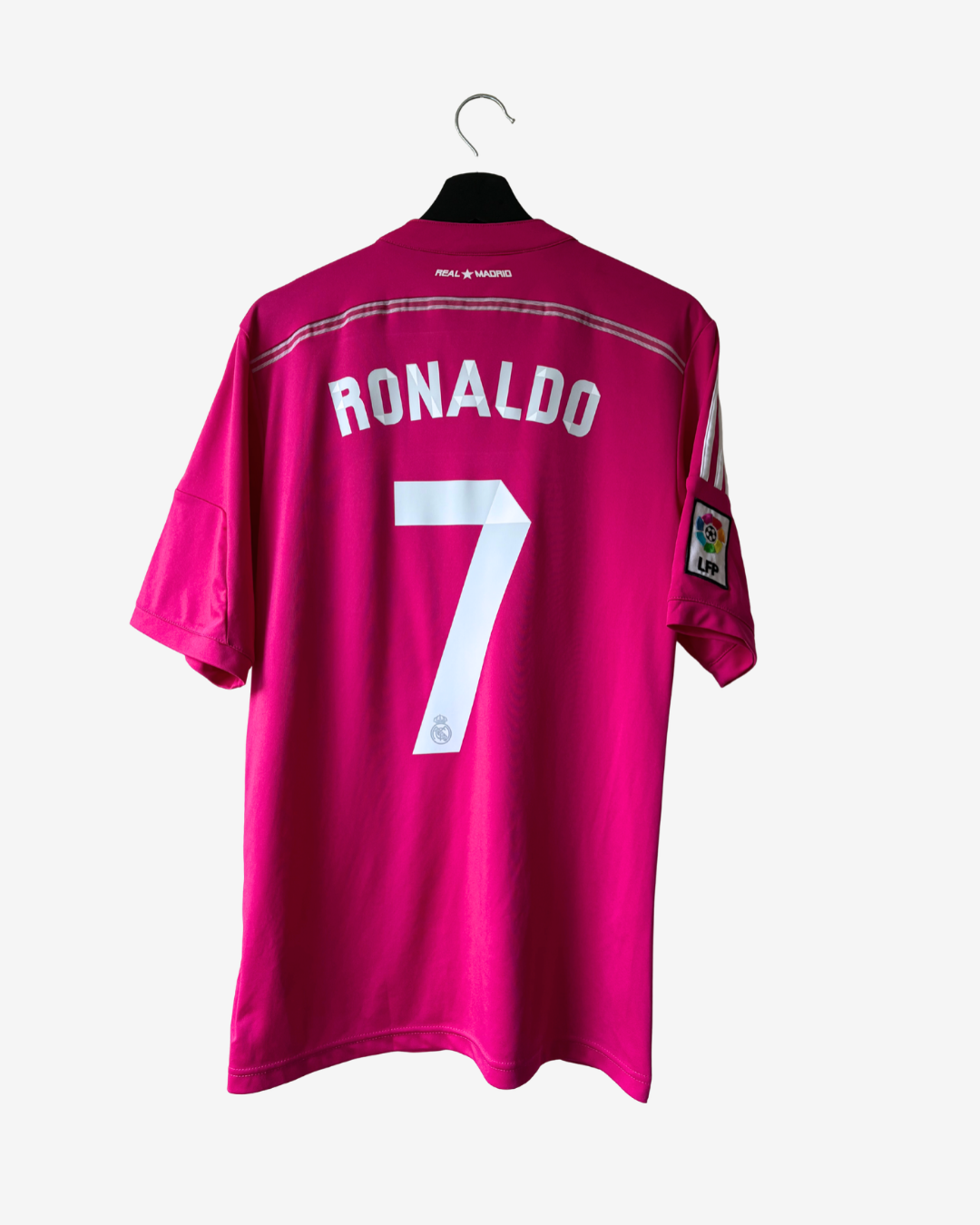 A bright pink soccer jersey hanging on a black hanger against a light gray background. The back of the shirt features 'RONALDO' and the number '7' in white, with a LaLiga patch on the sleeve.