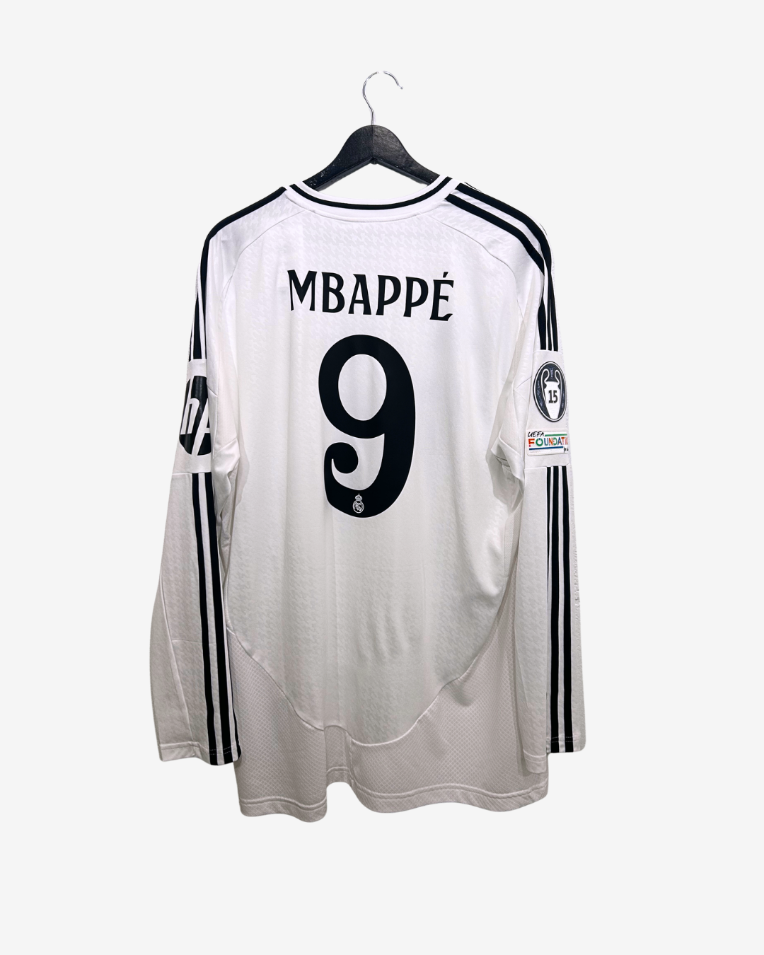 White soccer jersey with 'Mbappé' and number '9' on a hanger against a white background
