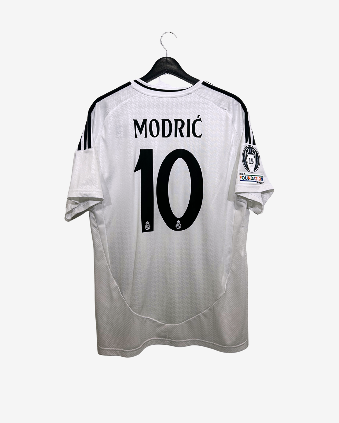 White soccer jersey with black numbering and text on a hanger against a white background