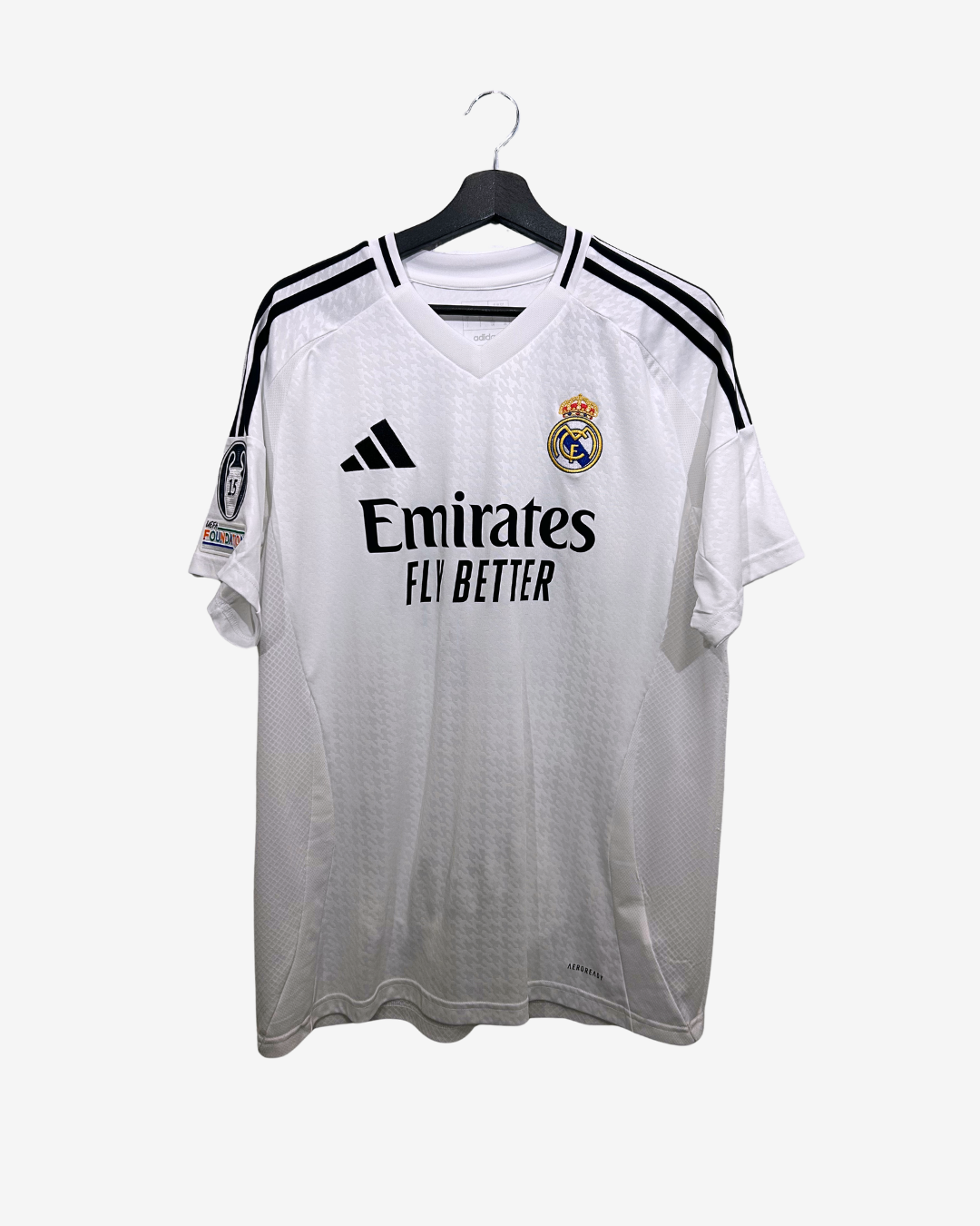 White sports jersey with black stripes and branding on a hanger against a white background